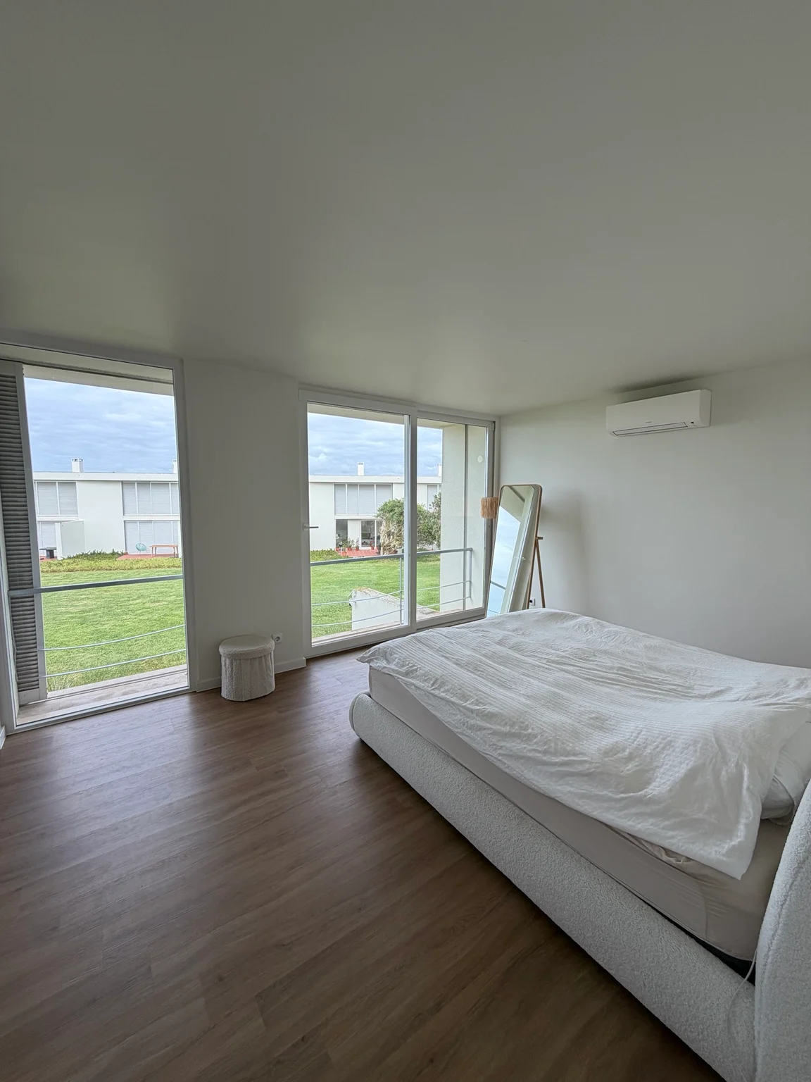 Main bedroom with windows facing the communal gardens