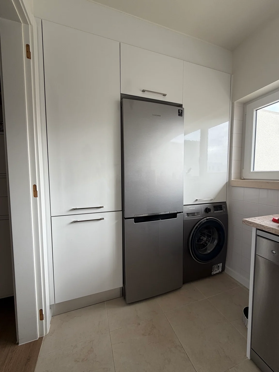 Kitchen fridge, washing machine and storage cabinets
